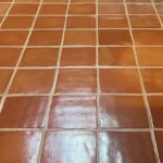 Close-up of clean, glossy Saltillo tile with evenly spaced grout lines, highlighting the tile's natural terracotta color and texture.